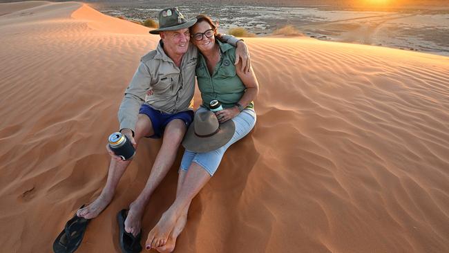 Greg and Sam Watkins take a break from their work in outback Birdsville to enjoy the sunset on the Big Red sand dune west of the town. Picture: Lyndon Mechielsen/The Australian