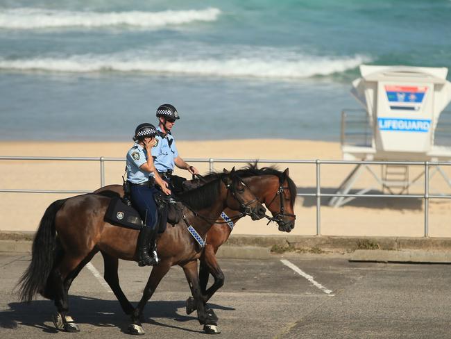 SYDNEY, AUSTRALIA - MARCH 22: Mounted Police patrol Bondi Beach as all eastern suberbs beaches are closed on March 22, 2020 in Sydney, Australia. Prime Minister Scott Morrison on Friday introduced further measures to help stop the spread of COVID-19, implementing news rules limiting the number of people inside a venue to one every 4 square metres. Non-essential gatherings of 100 or more people indoors are banned, along with outdoor gatherings of more than 500 people in a bid to contain the spread of COVID-19. A travel ban on all visitors who are not Australian citizens or residents or their direct relations arriving into the country is now in place. There are now 1286 confirmed cases of COVID-19 In Australia and the death toll now stands at seven. (Photo by Mark Evans/Getty Images)