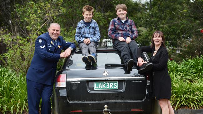 Leading Senior Constable Cameron Caine with his wife, Laura, and sons Harry and Angus. 