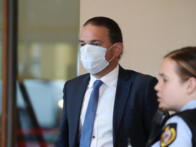 Steven Prestage gets a temperature check before entering Downing Centre Courts on July 9. Picture: NCA NewsWire/David Swift