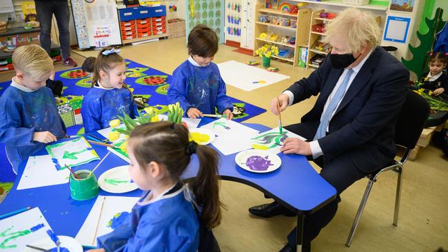 Prime Minister Boris Johnson sits and paints Tulips with children from Colham Manor primary school. Picture: Getty