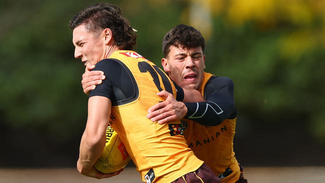 Massimo D’ambrosio tries to bring down Connor Macdonald at Hawks training. Picture: Quinn Rooney/Getty Images