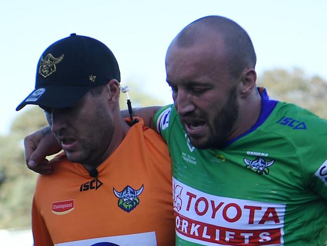 Canberra star Josh Hodgson helped off the field after suffering a knee injury in their season-opening win over Cronulla. Credit: NRL Images.