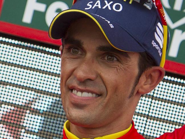 Tinkoff's Spanish cyclist Alberto Contador celebrates his red jersey on the podium of the 19th stage of the 69th edition of "La Vuelta" Tour of Spain, a 180,5 km ride from Salvaterra do Mino to Cagas do Morrazo on September 12, 2014. AFP PHOTO/ JAIME REINA