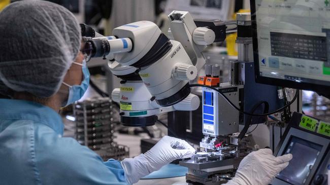 Workers on the production line building new cochlear implants the Sydney facility. Picture: NCA NewsWire / James Gourley