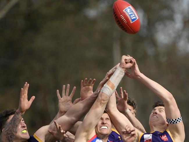 Players fly for the ball in the grand final. Picture: Andy Brownbill