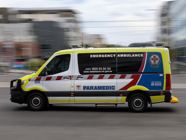 MELBOURNE, AUSTRALIA - NewsWire Photos FEBRUARY 13, 2022: An ambulance speeds away from the Royal Melbourne Hospital. Ambulance, Generic.Picture: NCA NewsWire / David Geraghty