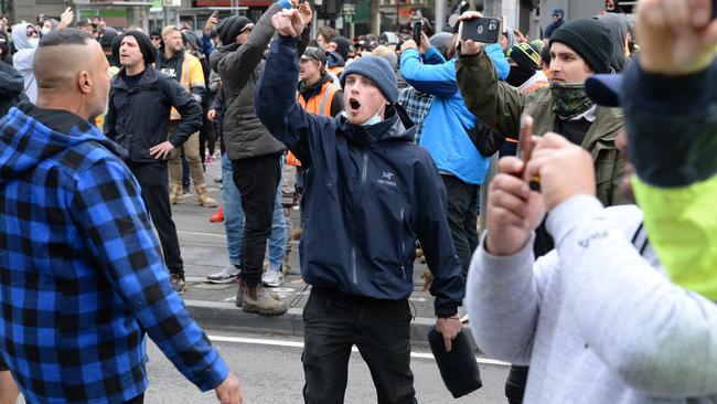 Protesters abuse police as they walk through central Melbourne. Picture: Andrew Henshaw