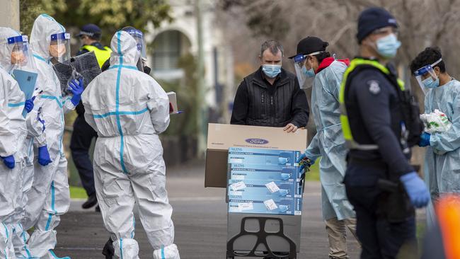 Police and medical people in PPE at Hambleton House, a boarding house for homeless people at 46 St Vincent Place, North St Albert Park, Melbourne. Picture: Tim Carrafa