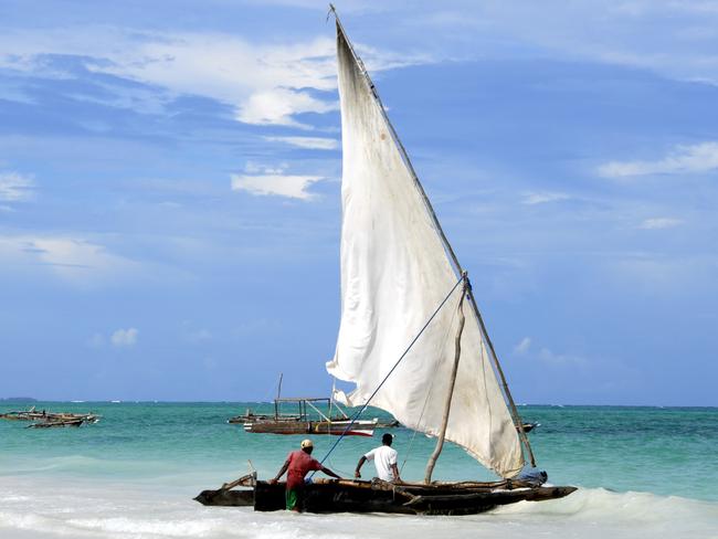 Fishermen and their dhow, Kiwengwa Beach,Zanzibar,Tanzania.