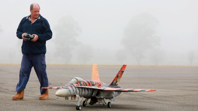 Pilot Jeff Sparkes with his Canadian Tiger F18 Hornet at the TAFE grounds in Quakers Hill. Pictures: Angelo Velardo