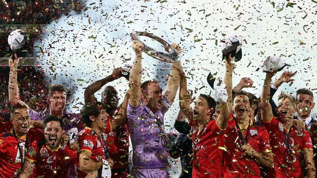 Adelaide United players celebrate winning the A-League grand final