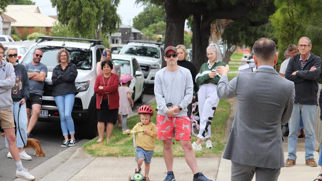 Belmont man Steven Trotter, centre, was the successful bidder at Laura Ave on Saturday. The underbidders lead on their car, left. Picture: Peter Farago