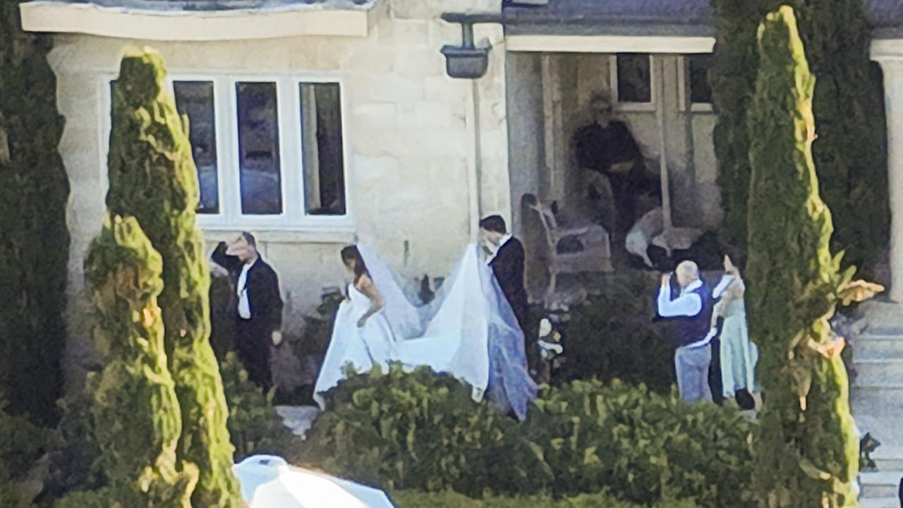 Pat Cummins helps his bride Becky Boston with the train of her gown. Picture: WP/MEDIA-MODE