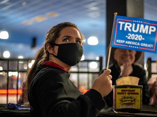 An attendee at a watch party for Republicans waves a Trump 2020 flag on election day, November 3, 2020 in Austin, Texas. (Photo by Sergio Flores / AFP)