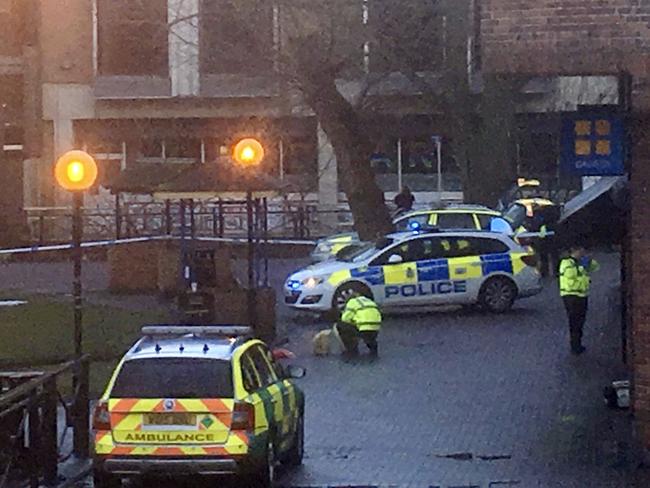 A police officer without any protective gear crouches down next to the bench where Sergei Skripal and his daughter Yulia were found. Picture: Thomas Belk/Solent News &amp; Photo Agency via AP