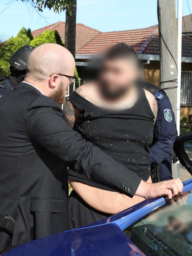 Alleged drug dealer Danny Watfa speaks with detectives before being placed inside an unmarked police vehicle bound for Bankstown Police Station. Picture: NSW Police Force
