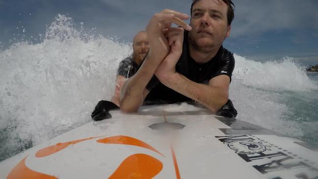 Mark Leslie is able to surf again despite being paralysed