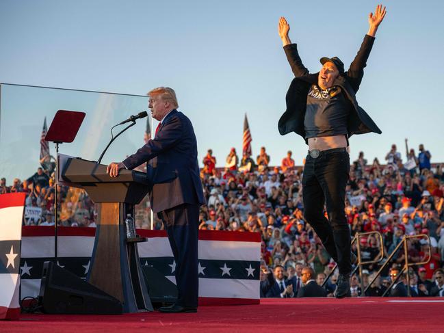 Elon Musk jumps on stage as he joins Donald Trump during a campaign rally. Picture: Jim Watson / AFP