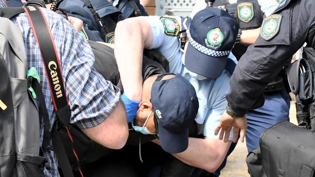 Police arrest a man in Sydney’s CBD on Saturday. Picture: Matrix