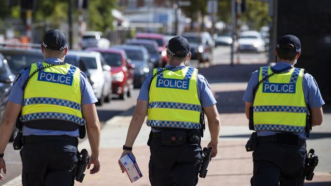 Police on patrol at a COVID-19 drive-through clinic in Perth during this week’s five-day snap lockdown. Picture: Getty