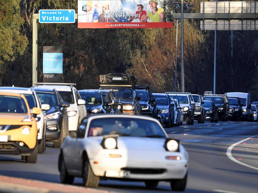 Commuters queue as police in the southern NSW border city of Albury check cars crossing the state border from Victoria on July 8. Picture: William West