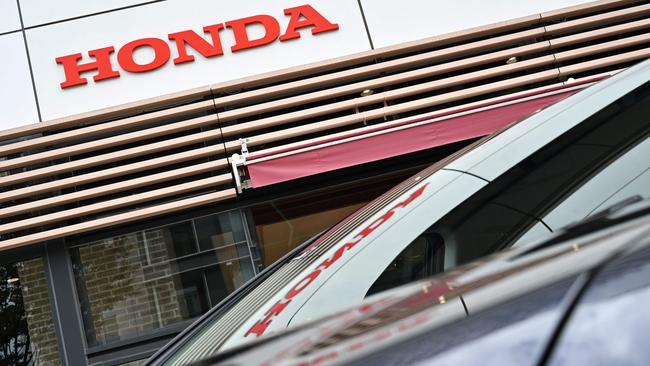 A Honda logo outside a dealership in Tokyo. (Photo by Philip FONG / AFP)