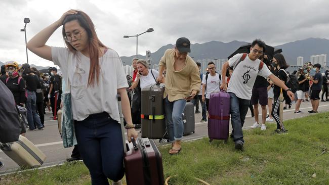 Travellers were forced to abandon their buses and walk to the airport. Picture: AP,