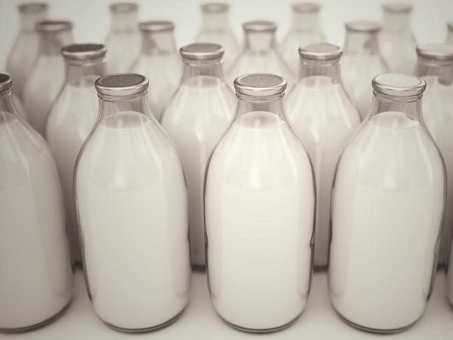 RendezView. Front shot of old-fashioned glass bottles filled with milk on a white backround. Perfect for any health or natural nutricion realted purposes. Milk.