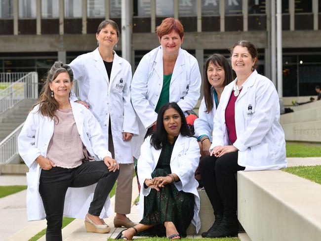 A/Prof Maria Parappilly OAM, centre, with Prof Karen Burke de Silva, Prof Briony Forbes, (back) Prof Melissa Brown, Prof Claire Lenehan and Prof Catherine Abbott. The professors don lab coats to show not all heroes wear capes ahead of International Women's Day. Picture: AAP/ Keryn Stevens