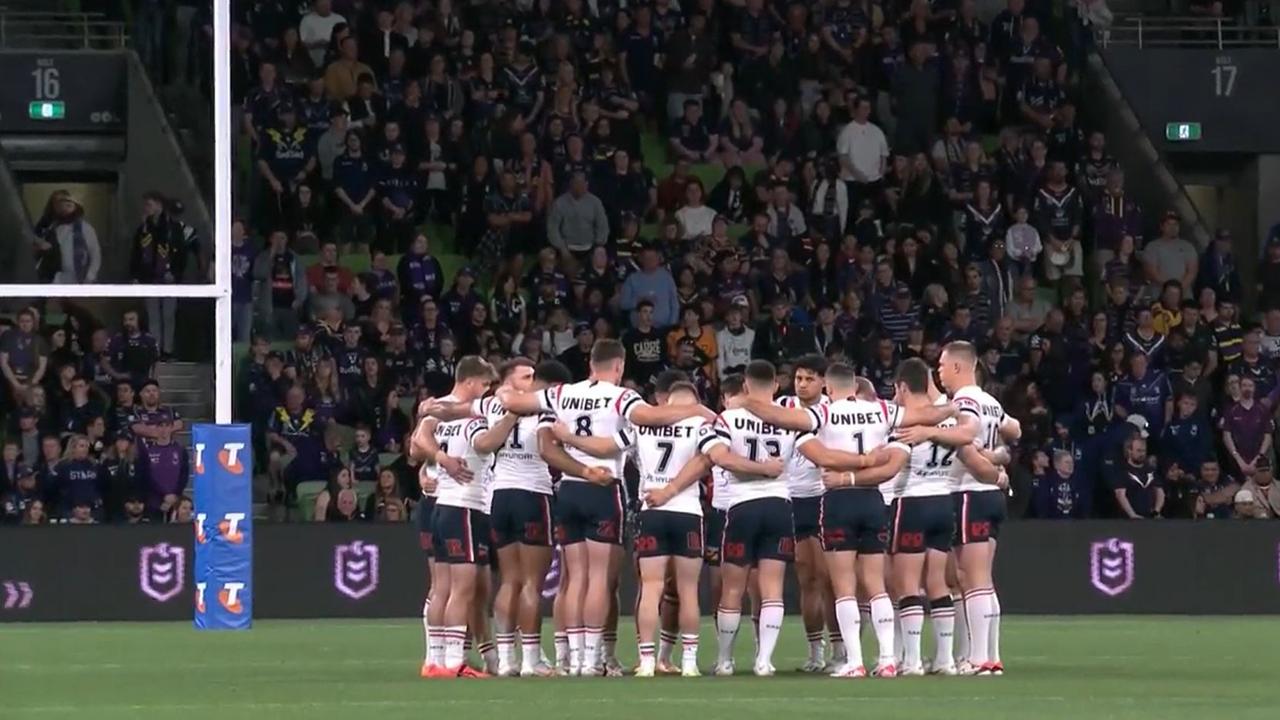 The Roosters players huddle to pay their respects.