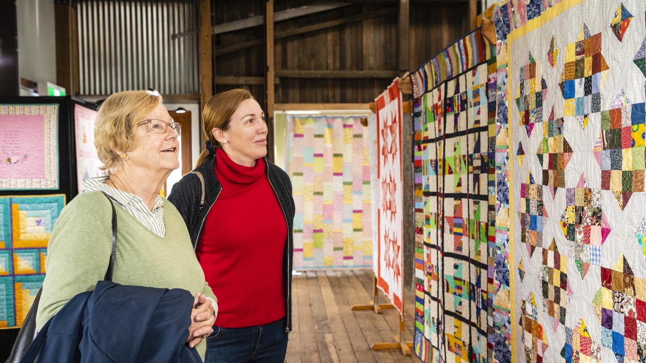 Anneke Schrale and daughter-in-law Rebecca Schrale admire the Toowoomba Quilters Club work on show at Craft Alive at the Goods Shed, Sunday, May 22, 2022. Picture: Kevin Farmer