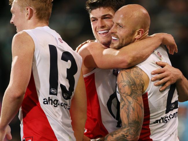 Nathan Jones of the Demons is congratulated by team mates Angus Bradshaw and Clayton Oliver of the Demons during the Round 21 AFL match between the Port Adelaide Power and the Melbourne Demons at Adelaide Oval in Adelaide, Saturday, Aug. 13, 2016. (AAP Image/Ben Macmahon) NO ARCHIVING, EDITORIAL USE ONLY