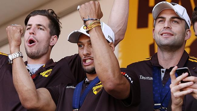 Hawk Ben Stratton celebrates the flag with Josh Gibson and Brian Lake. Picture: Wayne Ludbey 