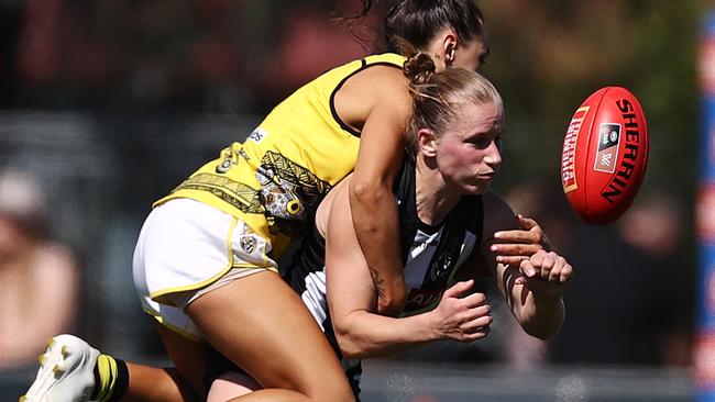 Best-on-ground Jaimee Lambert clears as she is tackled by Richmond’s Monique Conti. Picture: Michael Klein