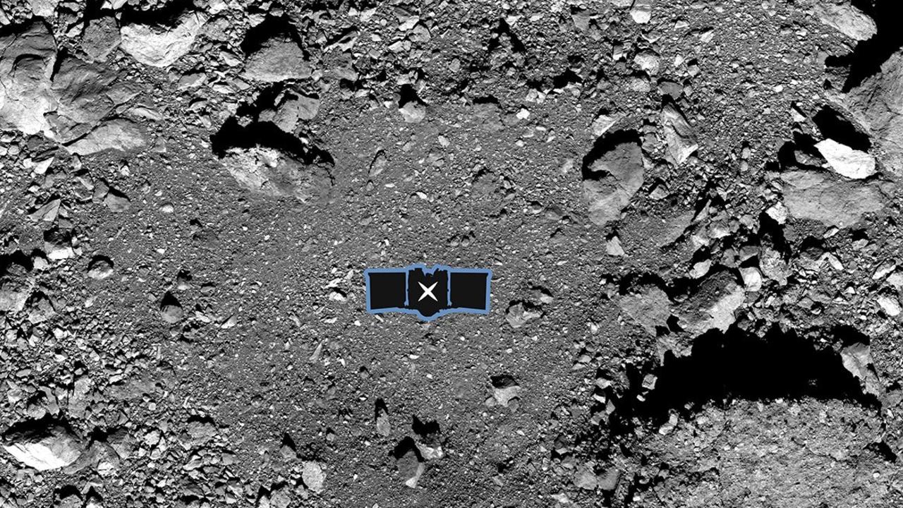 The Osiris-Rex spacecraft's primary sample collection site, named "Nightingale," on the asteroid Bennu. An outline of the OSIRIS-Rex spacecraft is placed at centre to illustrate the scale of the site, which is surrounded by boulders as big as buildings. Picture: NASA/Goddard/University of Arizona via AP