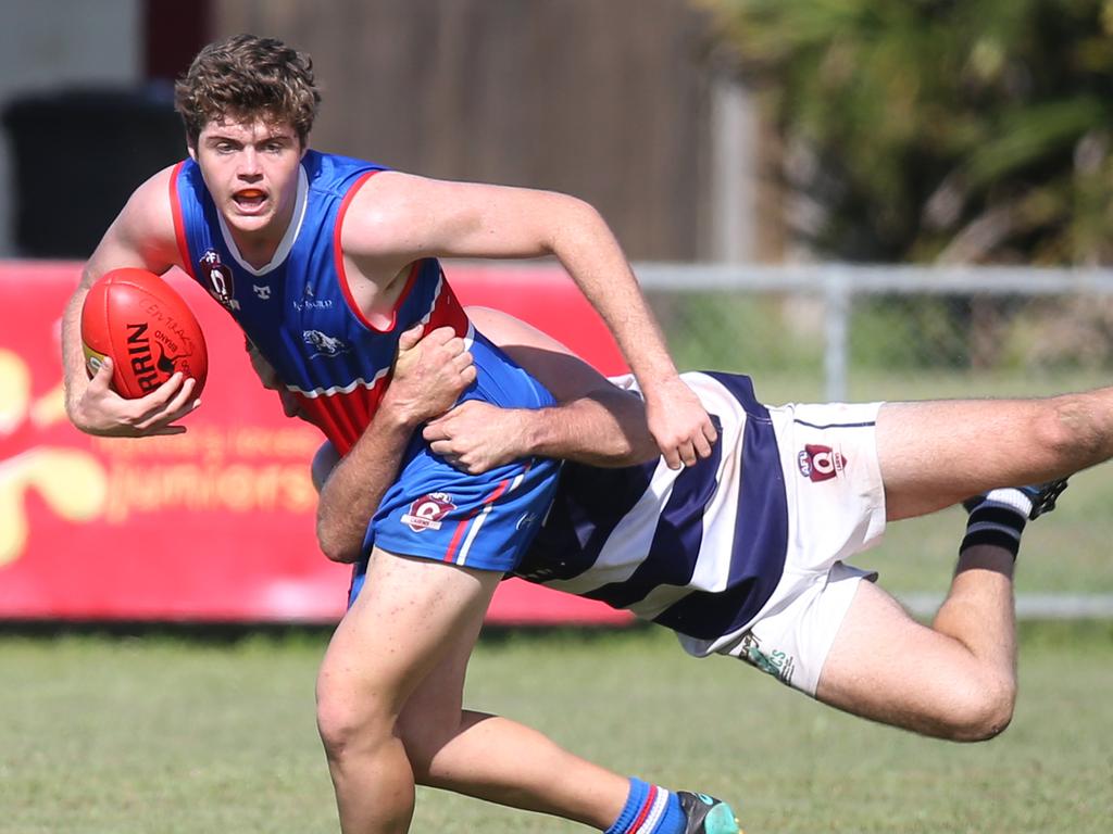 Jaiden Butson is wrapped up by Ethan McCollough in the AFL Cairns seniors match between Centrals Trinity Beach Bulldogs and Port Douglas Crocs, held at Crathern Park, Trinity Beach. Picture: Brendan Radke