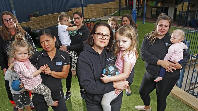 Cambridge Road Play and Learn Centre staff and children, (front) Jackie Hughes with Gracie Jenkins, 4 and (rear) Nat McNally, Lily Winzil with Eden Jordan, 2, Teresa Swain with Sophie Swain, 4, Cheynie Byrns with Henry Tyrell, 1 and Amelia Rogers with Piper Connors. The centre has seen an 80 per cent drop off in attendance during the COVID-19 crisis. Picture: ZAK SIMMONDS