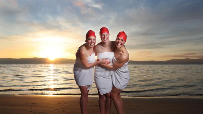 Friends L-R Sophie Jones, Eli Cropp and Olivia Carr from Hobart. Nude Solstice swim as part of Dark Mofo 2021 at Long Beach Sandy Bay. Picture: Nikki Davis-Jones