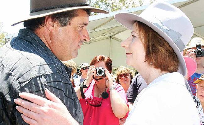 Prime Minister Julia Gillard greets a local at the Gatton commemorative flood service today. Picture: Rob Williams