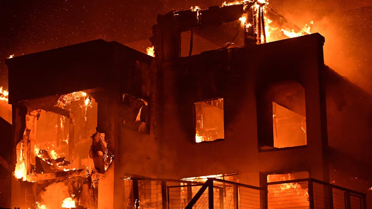 A house is engulfed in flames as the fire rages in LA. Picture: AGUSTIN PAULLIER / AFP