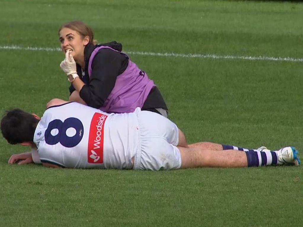 A Fremantle Dockers trainer points to her teeth to indicate the damage to Andrew Brayshaw after the Andrew Gaff hit. Picture: Fox Sports News