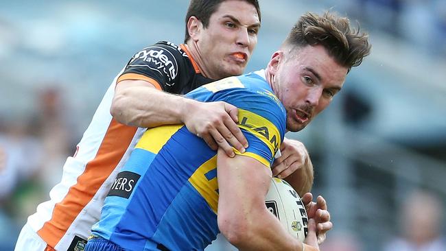 Mitchell Moses tackles Clint Gutherson.