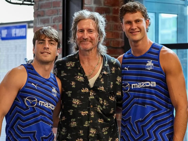North Melbourne players George Wardlaw and Charlie Comben with musician Tim Rogers