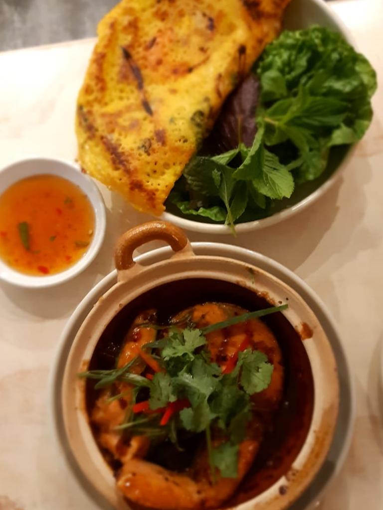 The clay fish hot pot and prawn pancake dishes. Picture: Chris Yamine