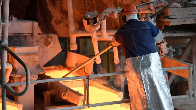 A worker handles molten copper at the at the Glencore Copper Smelter in Mount Isa. Picture: NCA NewsWire / Dan Peled