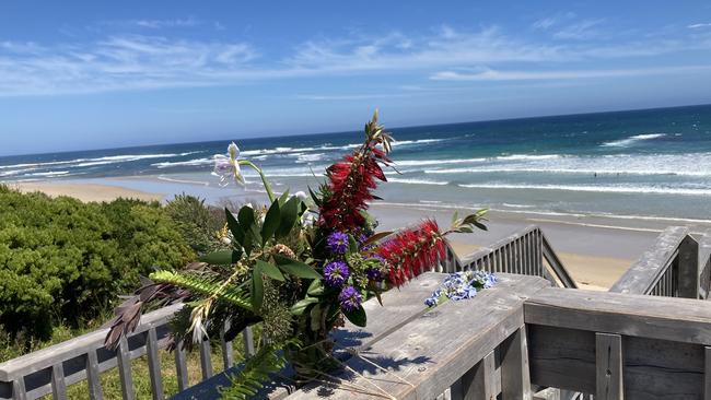 Floral tributes at Phillip Island’s Smiths Beach after a young woman drowned in December.