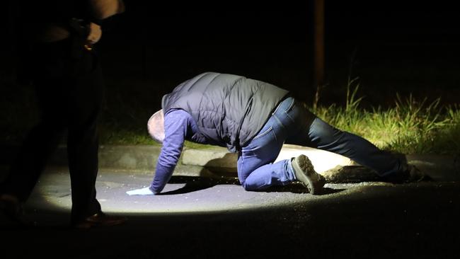 Tasmanian police inspect a property at Magra on Back River Road. Picture: Zak Simmonds