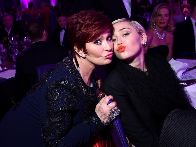 Sharon Osbourne and Miley Cyrus get cosy at the Elton John AIDS Foundation Academy Awards Viewing Party. Picture: Dimitrios Kambouris