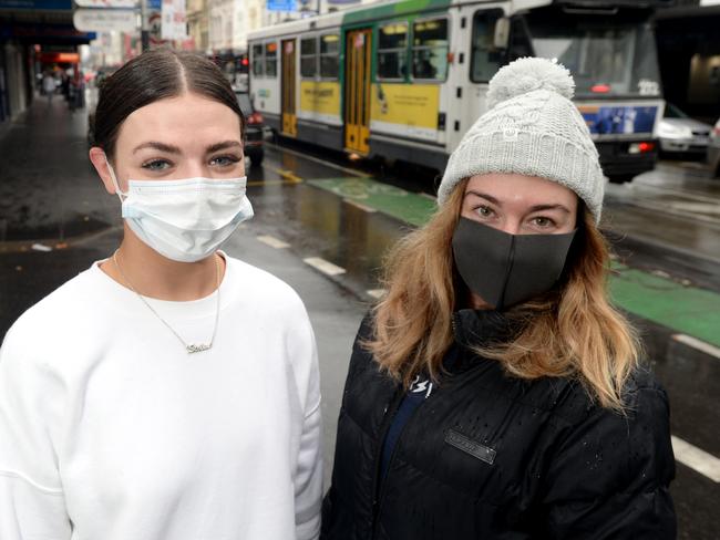 Flatmates Courtney Russ and Laura McCann have started wearing face masks in public, including when he's walking along Chapel Street, after the recent spike in COVID-19 cases in Melbourne. Picture: Andrew Henshaw